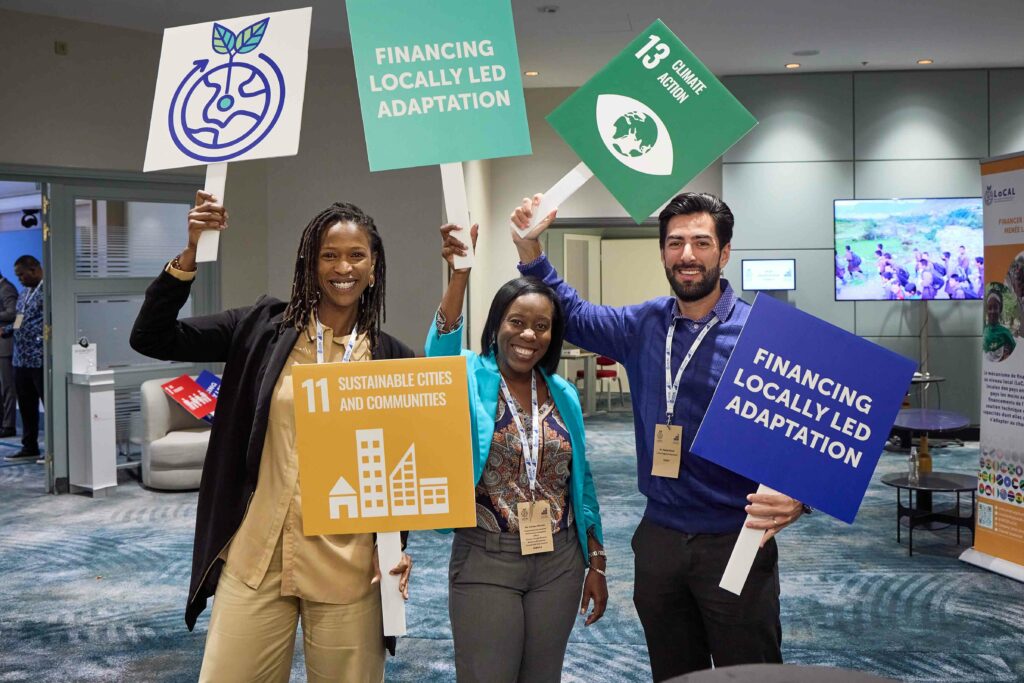 Workshop participants holding SDG signs.